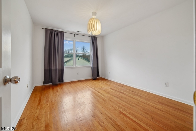 17 Grove Street Summit, NJ 07901 - Photo 32 of 42 a view of empty room with wooden floor and fan