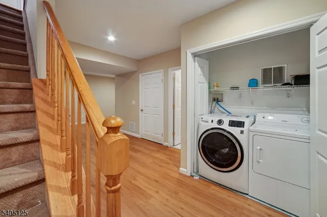 a view of a hallway with washer and dryer