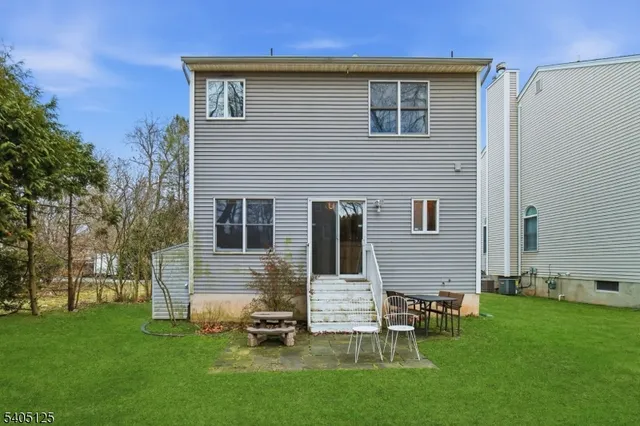 a backyard of a house with table and chairs