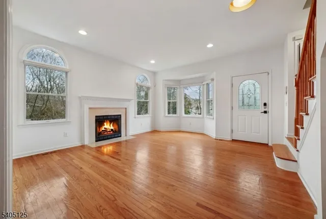 a view of an empty room with a window and fireplace