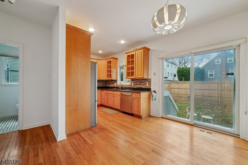 17 Grove Street Summit, NJ 07901 - Photo 7 of 42 a kitchen with kitchen island stainless steel appliances a large window and wooden floor