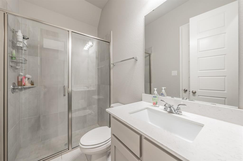 795 Knoxbridge Road Forney, TX 75126 - Photo 13 of 17 a bathroom with a sink toilet and shower