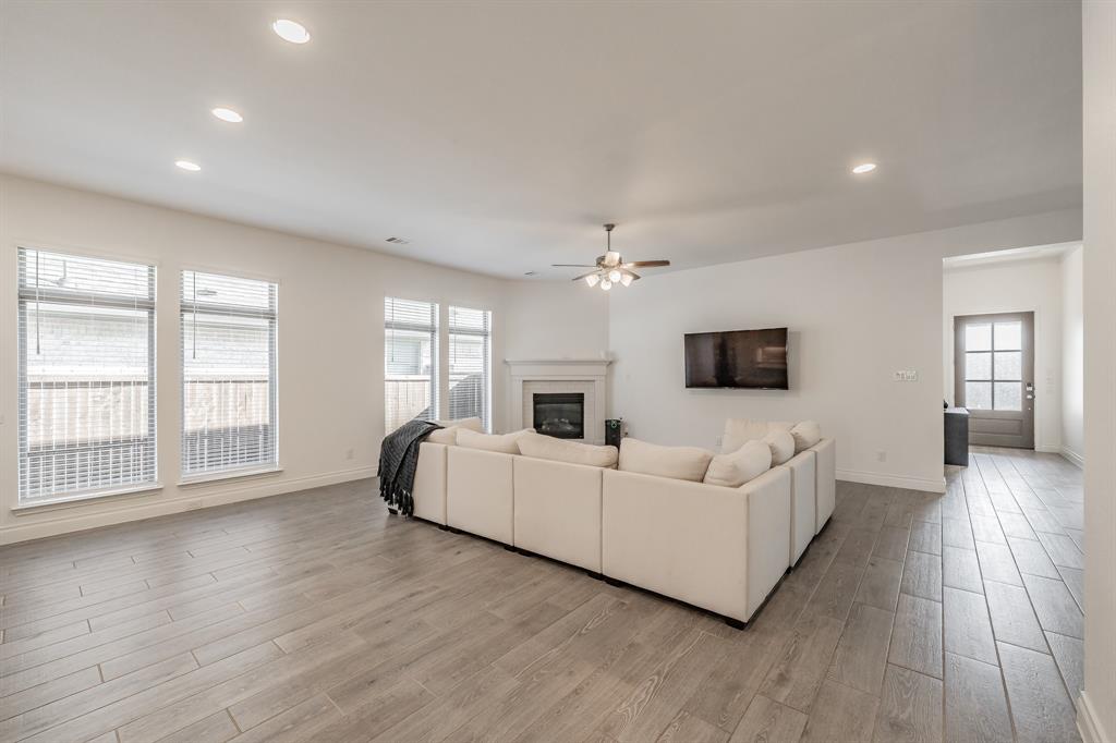 795 Knoxbridge Road Forney, TX 75126 - Photo 3 of 17 a living room with furniture and a flat screen tv
