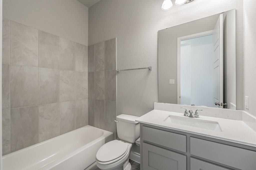795 Knoxbridge Road Forney, TX 75126 - Photo 6 of 17 a bathroom with a sink toilet and shower