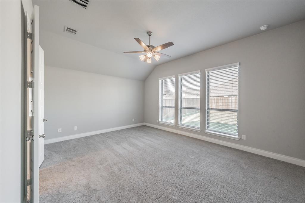 795 Knoxbridge Road Forney, TX 75126 - Photo 9 of 17 an empty room with chandelier fan and windows