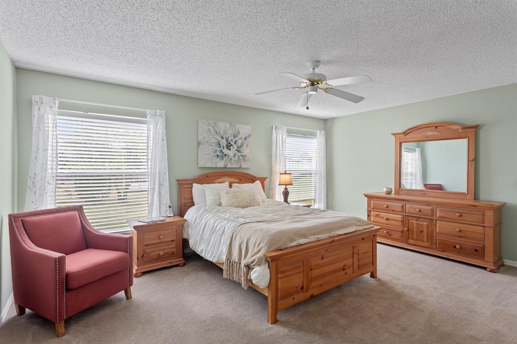 11751 Aintree Court Trinity, FL 34655 - Photo 19 of 45 a bedroom with a bed couch and window