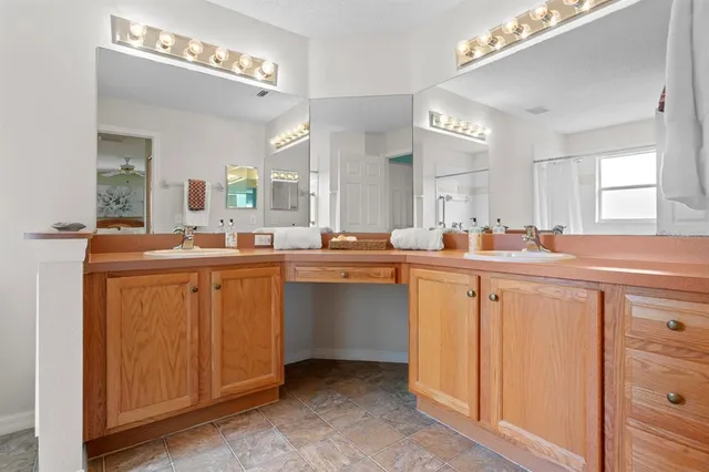 a kitchen with sink refrigerator and cabinets