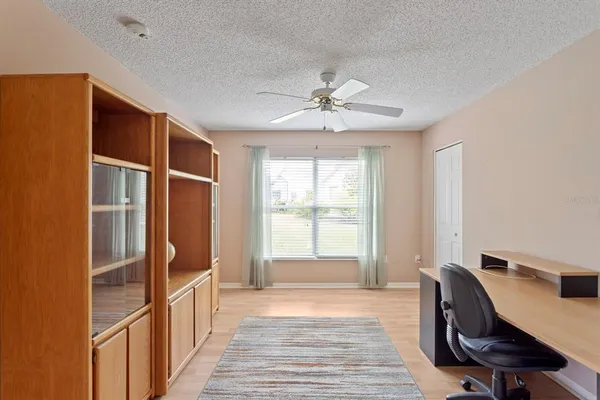 a view of a workspace with furniture and a window