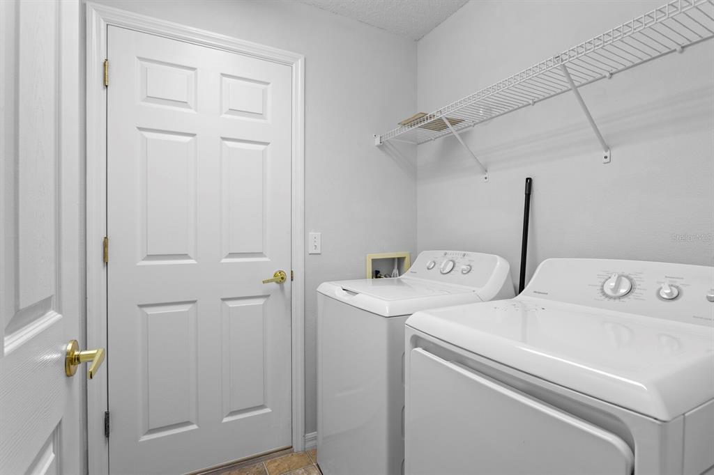 11751 Aintree Court Trinity, FL 34655 - Photo 31 of 45 a utility room with dryer and washer