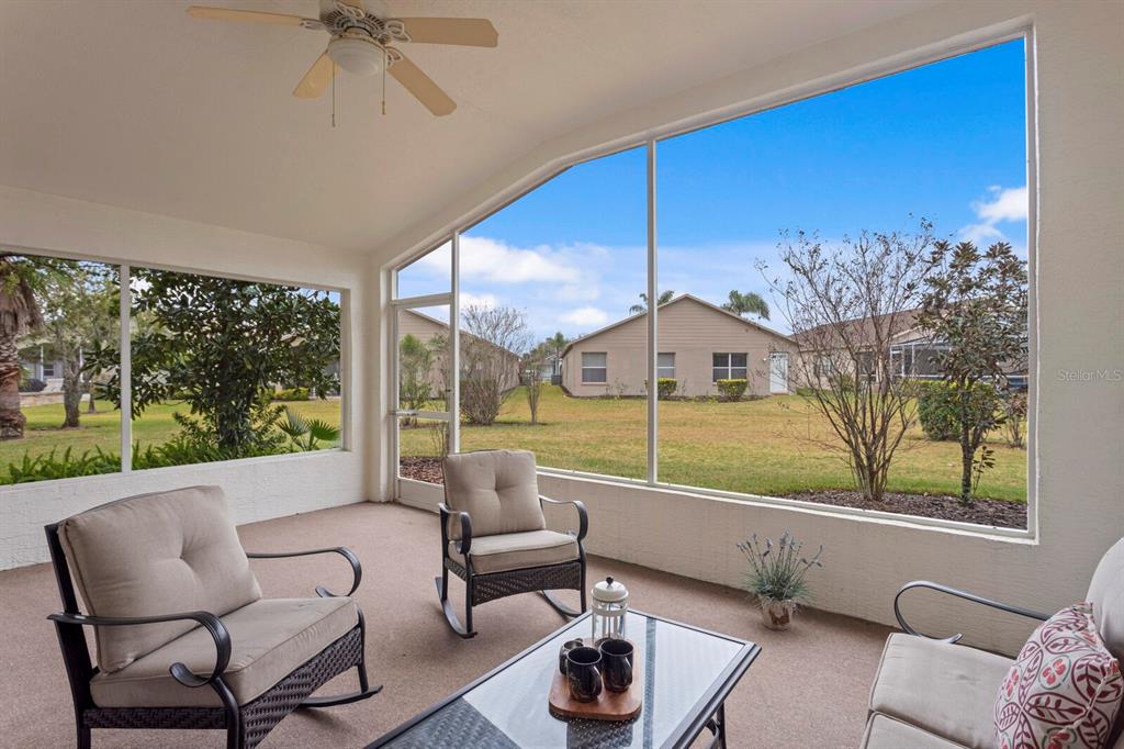 11751 Aintree Court Trinity, FL 34655 - Photo 32 of 45 a living room with furniture and a floor to ceiling window