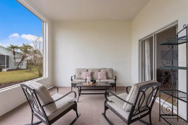 a living room with furniture and a floor to ceiling window
