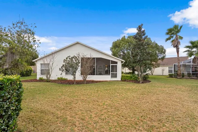 a front view of a house with a garden and yard