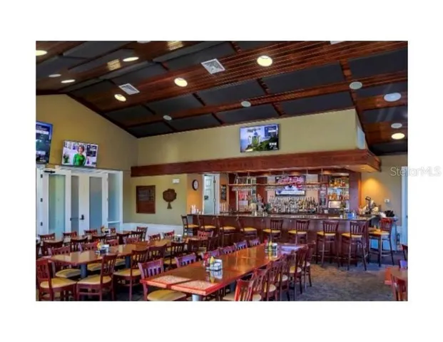 a view of a dining room with furniture and a chandelier