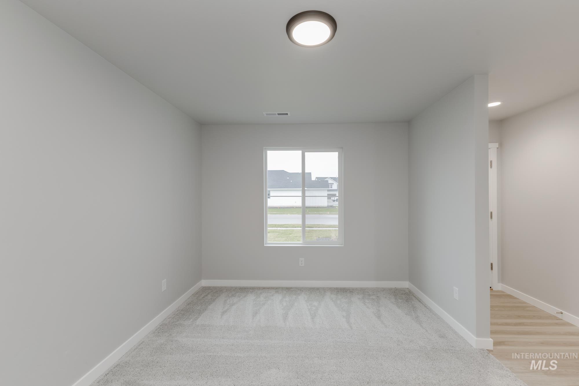1591 Covington Street Middleton, ID 83644 - Photo 10 of 23 Unfurnished room featuring light colored carpet and recessed lighting