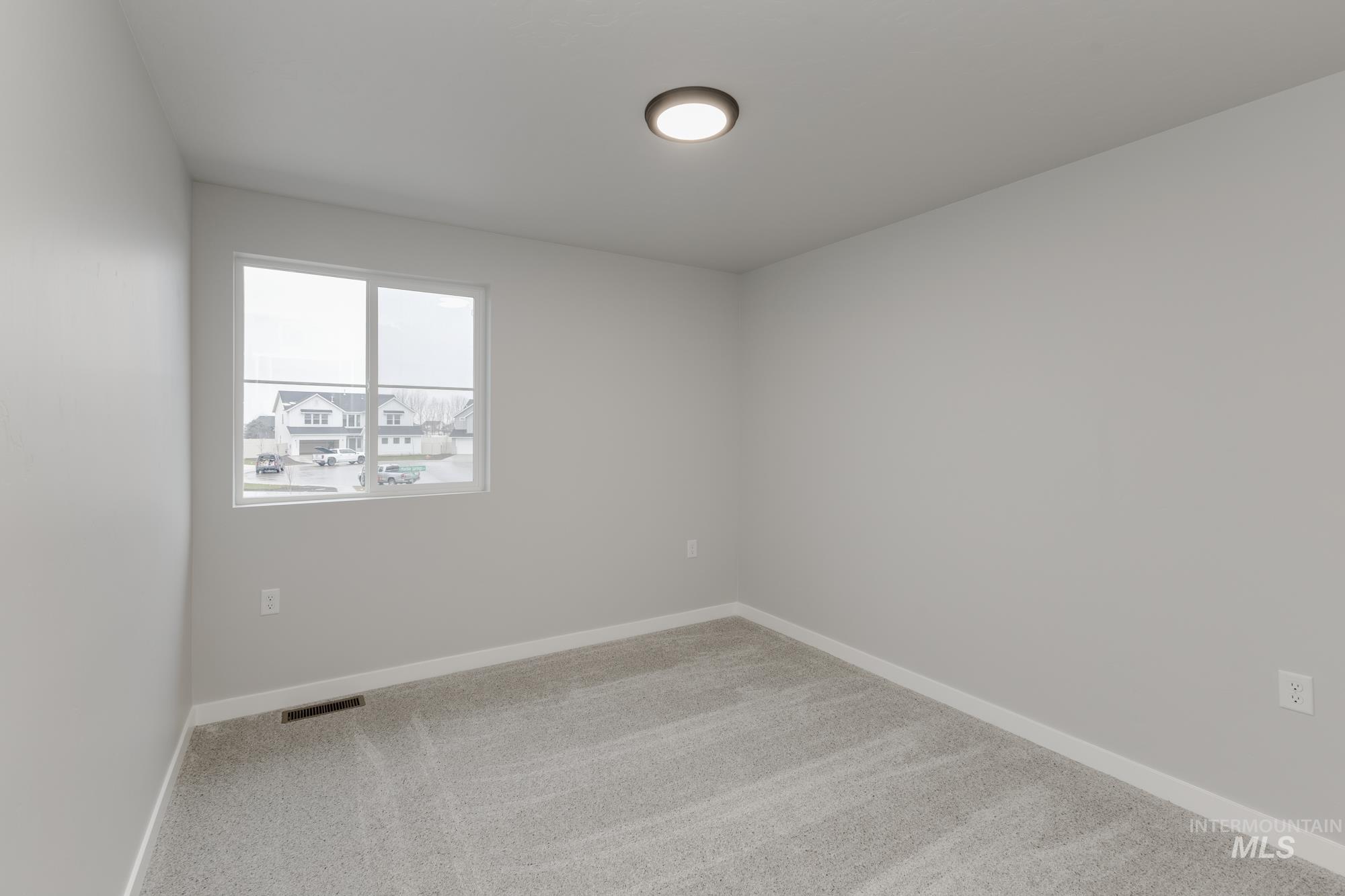1591 Covington Street Middleton, ID 83644 - Photo 15 of 23 Unfurnished room featuring light colored carpet and baseboards