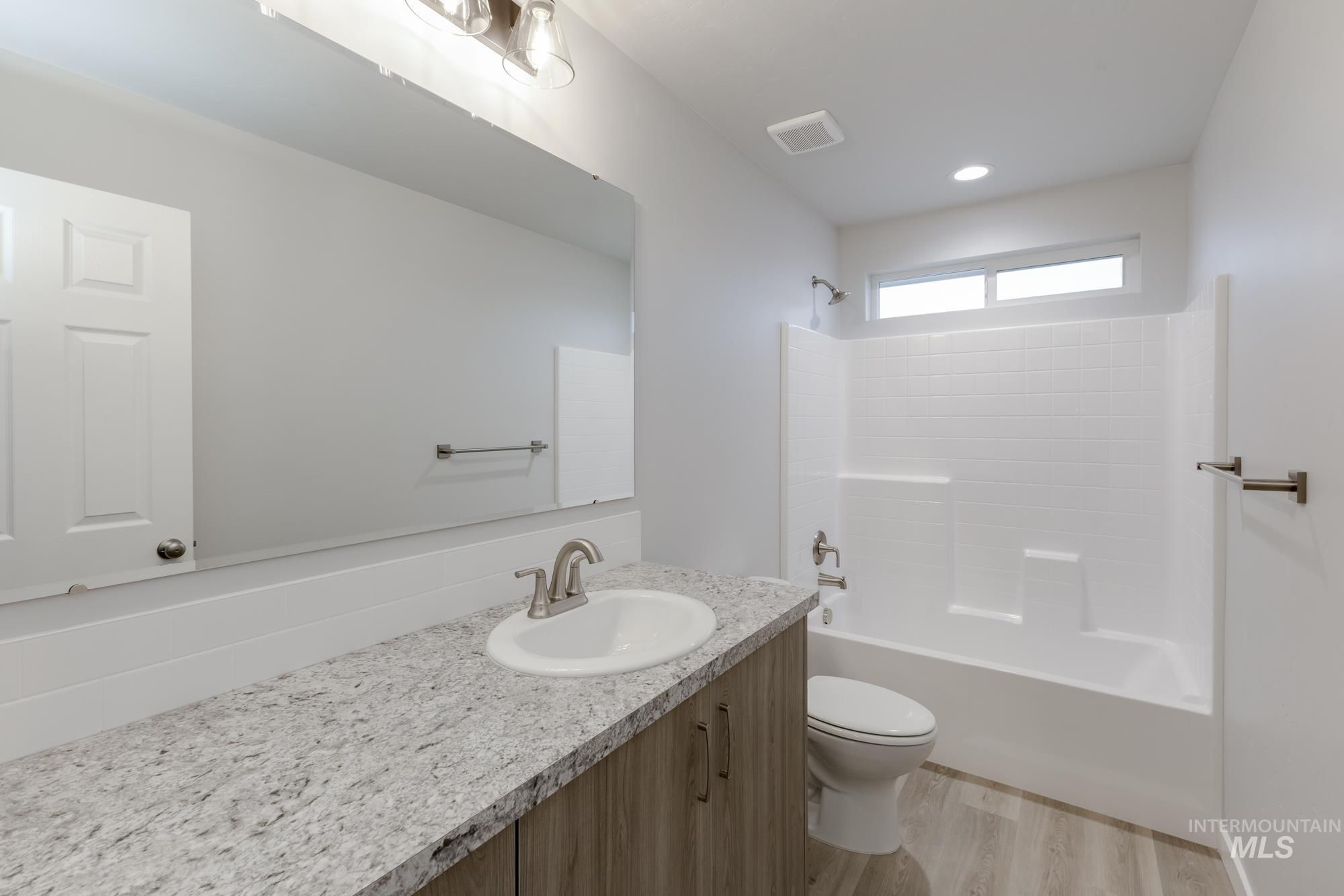1591 Covington Street Middleton, ID 83644 - Photo 17 of 23 Full bath featuring vanity, bathtub / shower combination, and light wood finished floors
