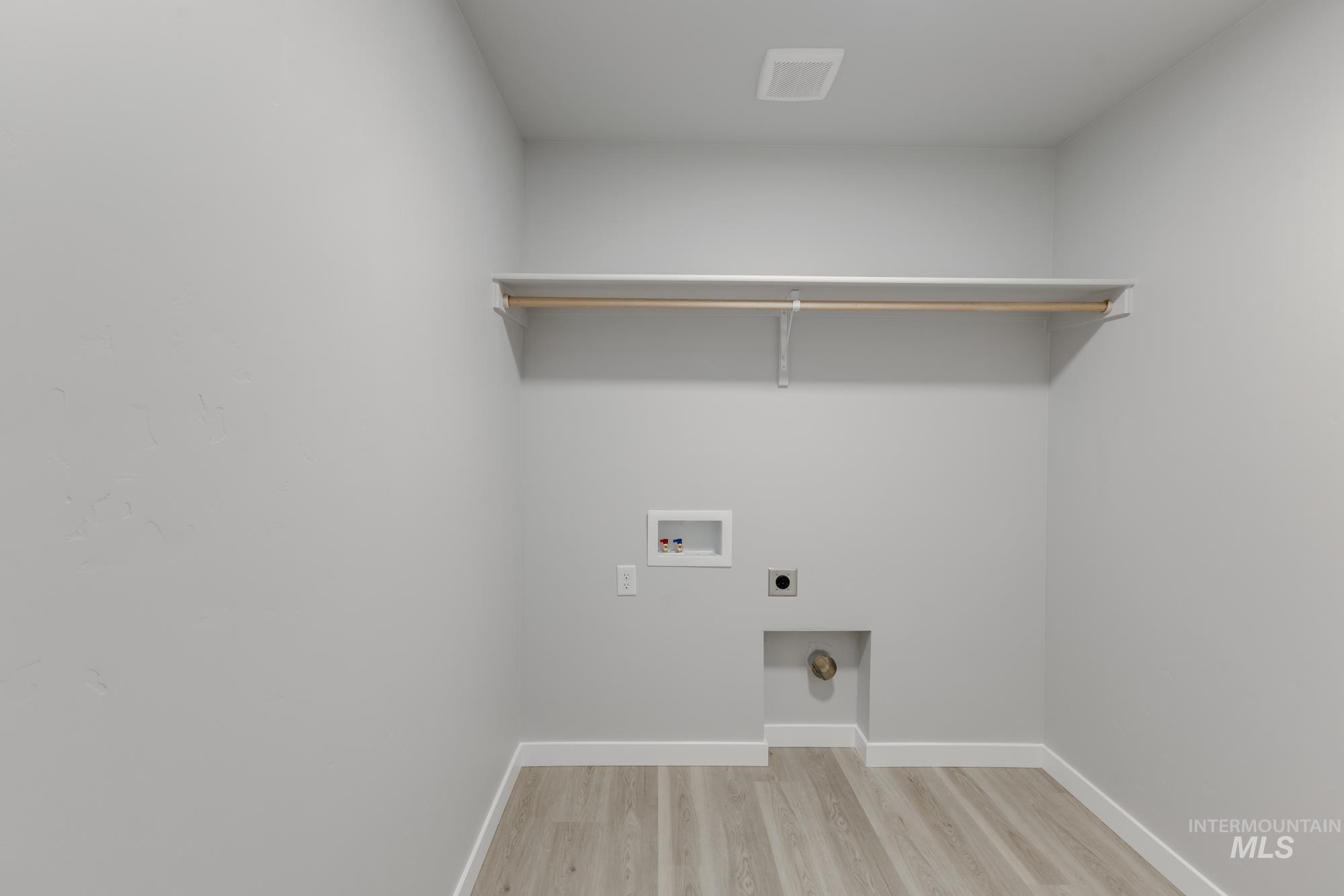 1591 Covington Street Middleton, ID 83644 - Photo 18 of 23 Laundry room featuring light wood-type flooring, hookup for an electric dryer, and washer hookup