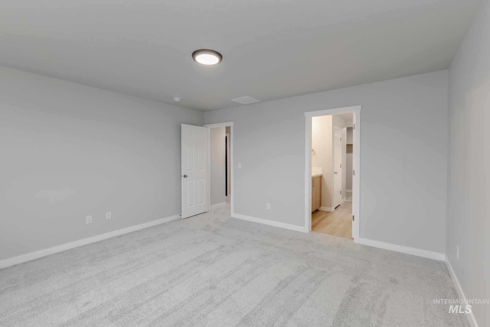 1591 Covington Street Middleton, ID 83644 - Photo 20 of 23 Unfurnished bedroom featuring light colored carpet and ensuite bathroom