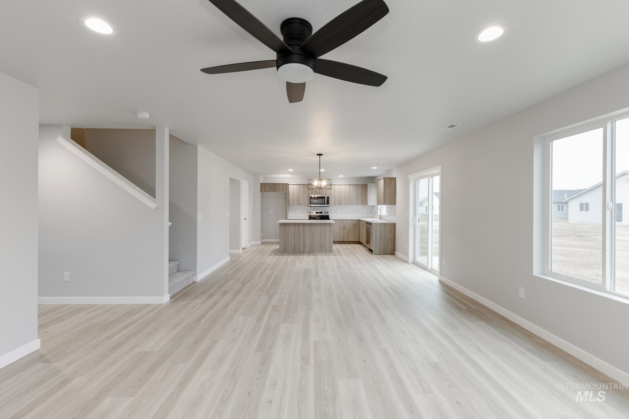 1591 Covington Street Middleton, ID 83644 - Photo 8 of 23 Unfurnished living room with recessed lighting, light wood-style floors, ceiling fan, and stairs