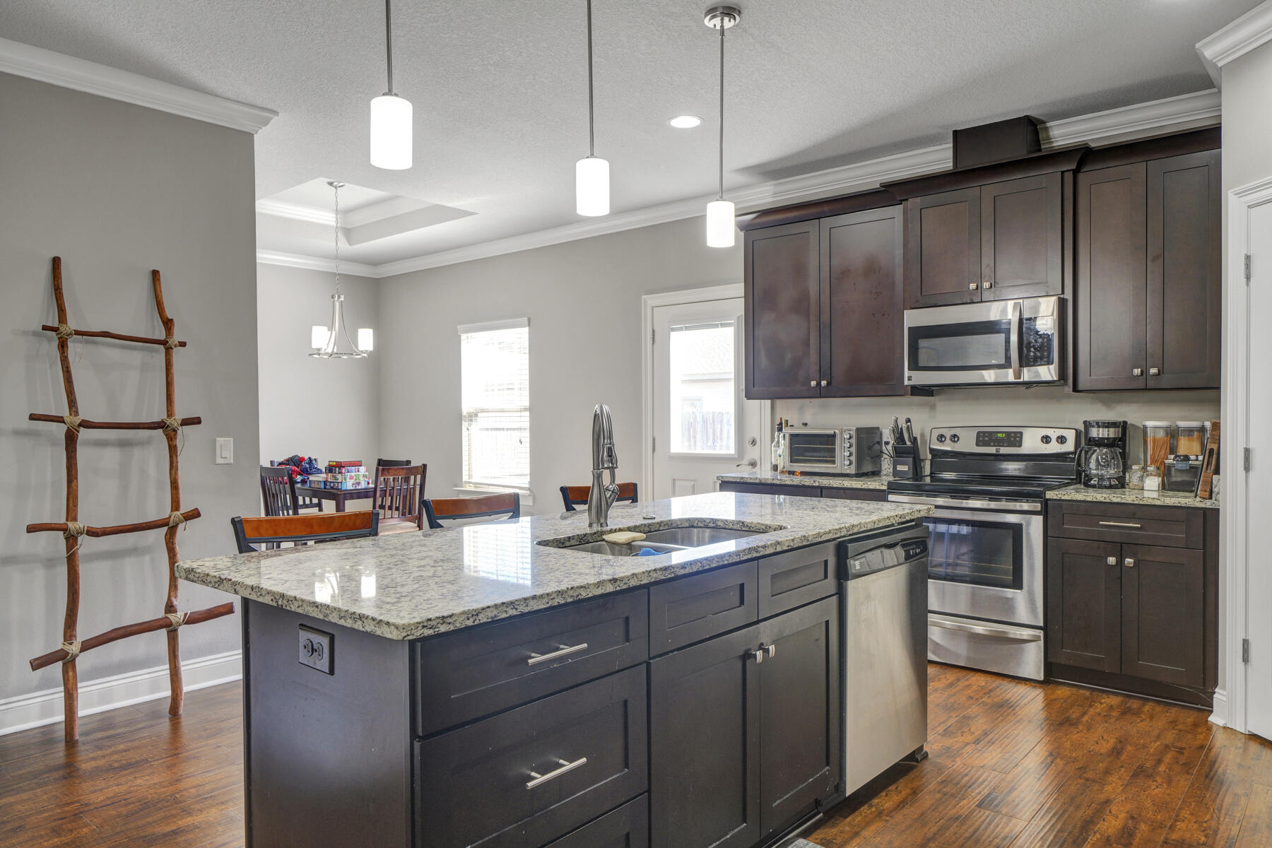 2136 Nina Street Navarre, FL 32566 - Photo 6 of 28 a kitchen with a sink stove and wooden cabinets