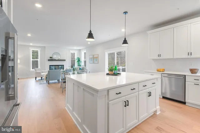 a kitchen with stainless steel appliances kitchen island granite countertop a sink a stove and cabinets