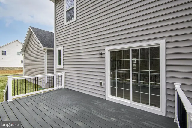 a view of balcony with wooden floor and fence