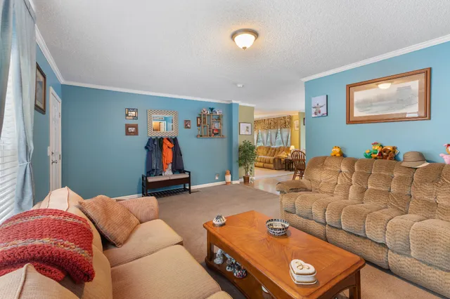 a large kitchen with stainless steel appliances granite countertop wooden floors wooden cabinets a sink and a island