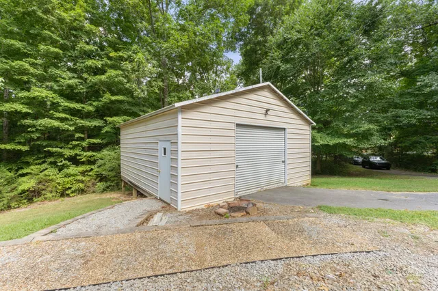 a view of a house with a yard and sitting area