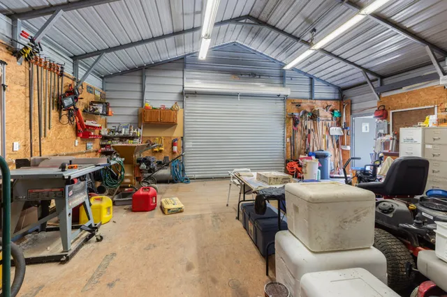 a view of a backyard with wooden fence and large trees