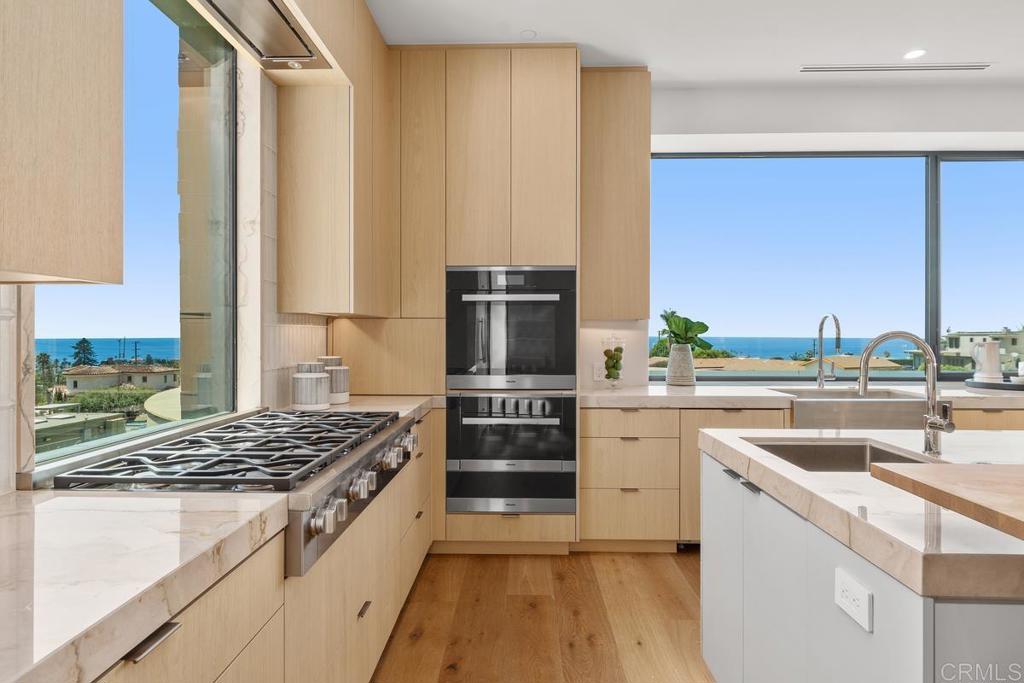 431 Marview Lane Solana Beach, CA 92075 - Photo 11 of 37 a kitchen with a stove a sink and a refrigerator