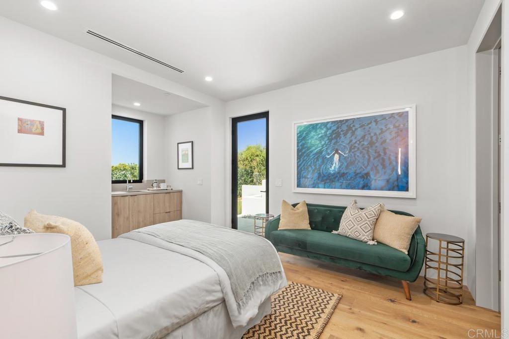 431 Marview Lane Solana Beach, CA 92075 - Photo 18 of 37 a bedroom with a bed and wooden floor