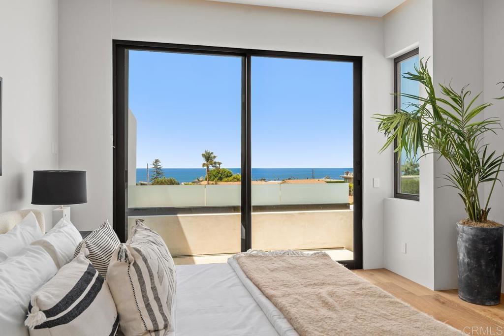 431 Marview Lane Solana Beach, CA 92075 - Photo 25 of 37 a view of a bedroom with a bed and large window