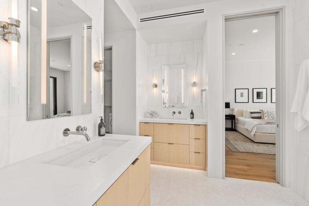 431 Marview Lane Solana Beach, CA 92075 - Photo 28 of 37 a en suite bathroom with a double vanity sink a mirror and a bathtub