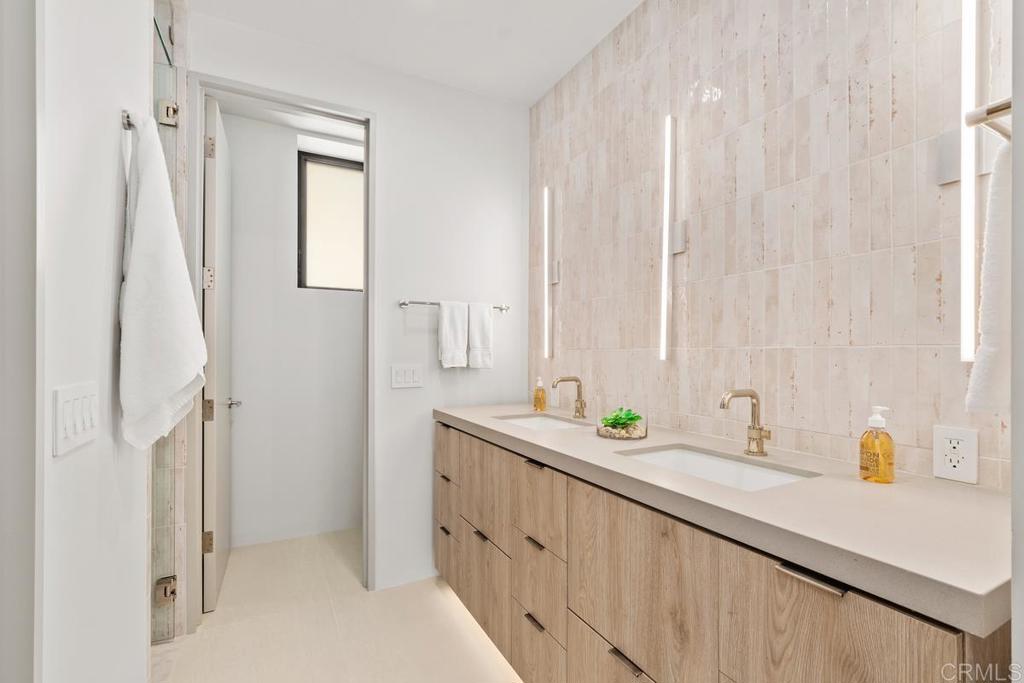 431 Marview Lane Solana Beach, CA 92075 - Photo 31 of 37 a bathroom with a double vanity sink and a mirror