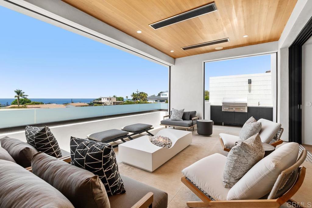 431 Marview Lane Solana Beach, CA 92075 - Photo 35 of 37 a living room with furniture and a floor to ceiling window