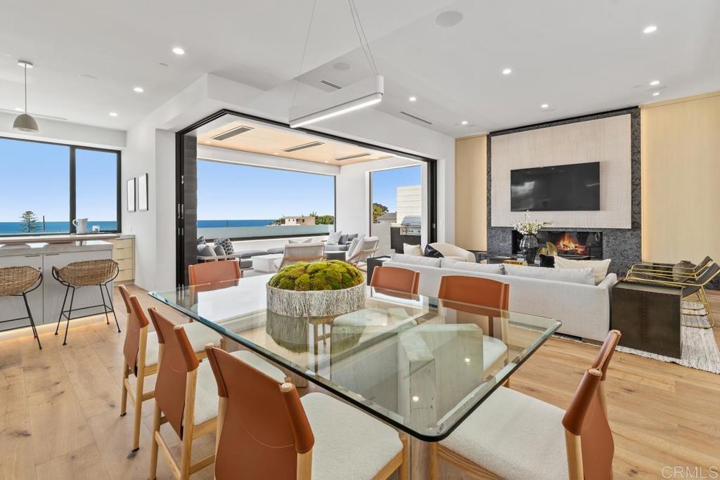 431 Marview Lane Solana Beach, CA 92075 - Photo 5 of 37 a dining room with large glass windows and furniture