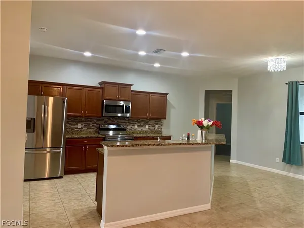 an empty room with a empty space and chandelier fan