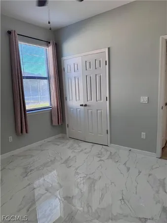 a view of a livingroom with a ceiling fan and window