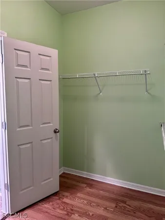 a view of a room with wooden floor