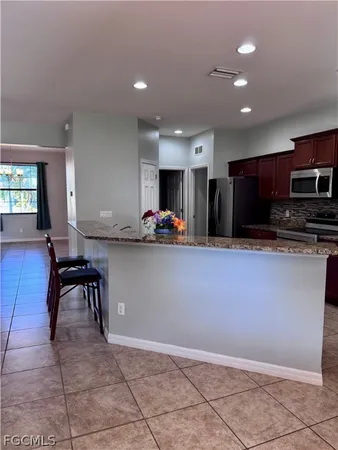 a kitchen with stainless steel appliances granite countertop a sink stove and cabinets