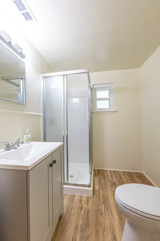 a bathroom with a sink toilet and shower