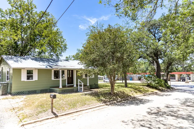 a view of a house with a tree in the background