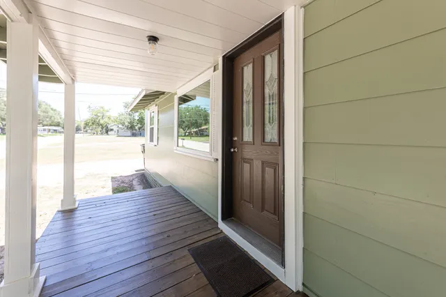 a view of a room with wooden floor and outdoor space