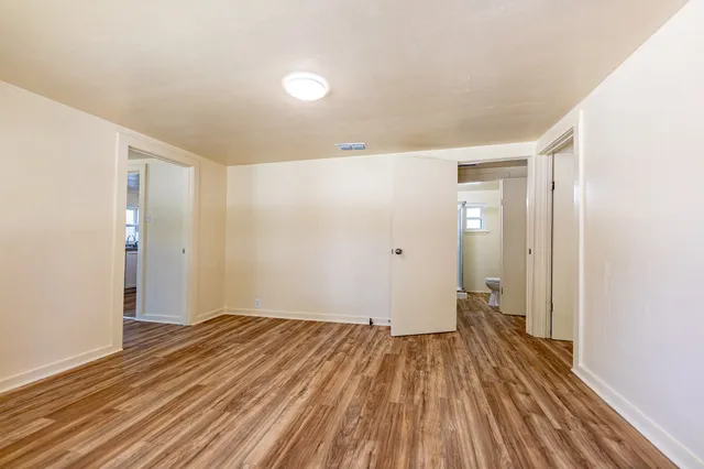 a view of a room with wooden floor