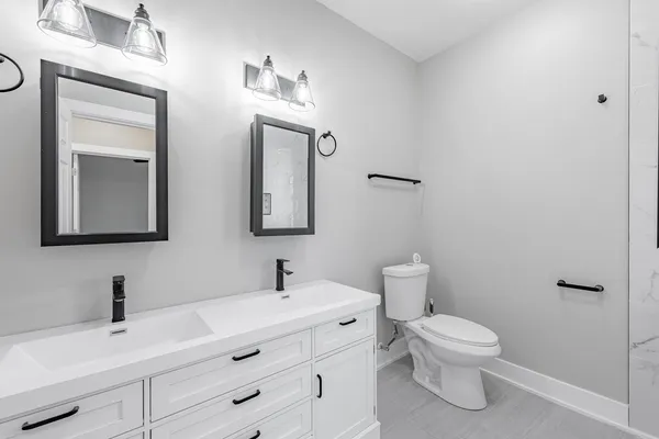 a bathroom with a toilet sink and mirror