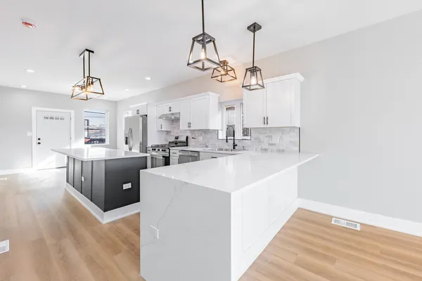 a view of a kitchen sink and chandelier