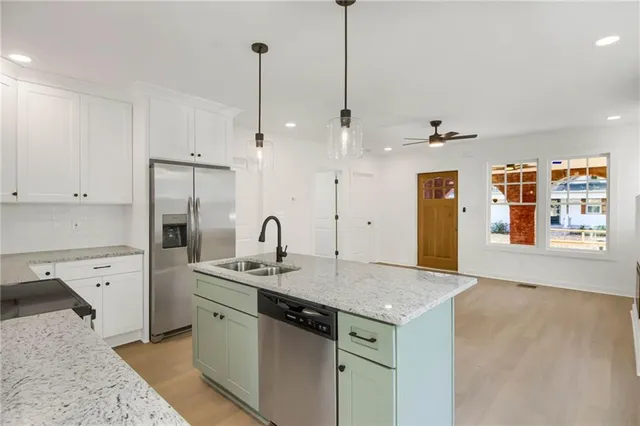 a kitchen with a sink a refrigerator and window