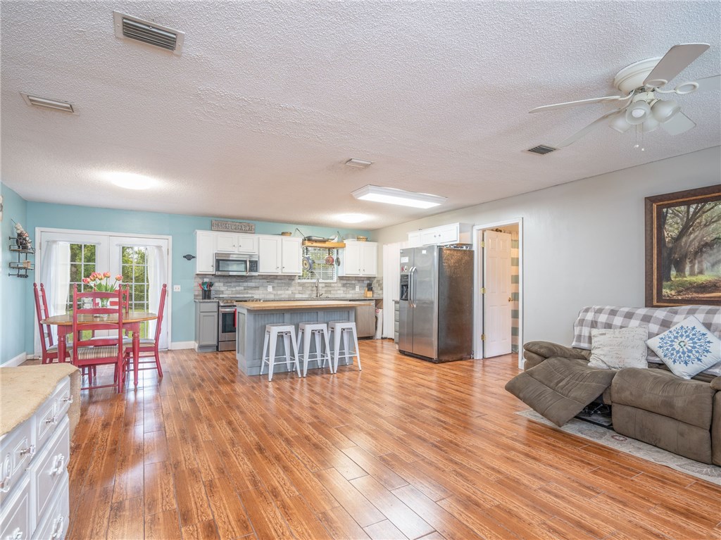 96722 Blackrock Road Yulee, FL 32097 - Photo 3 of 19 a living room with furniture and kitchen view