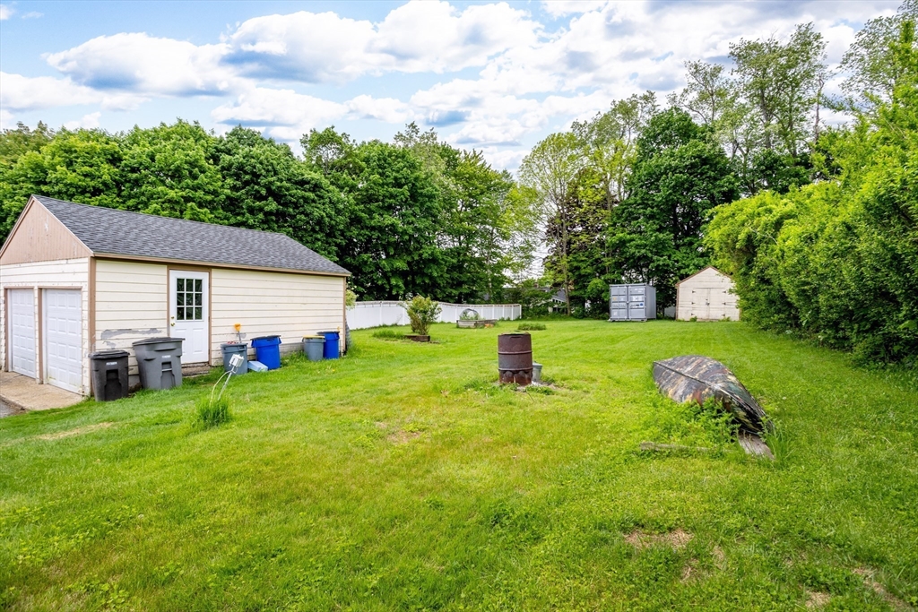 54 Charles Street Gardner, MA 01440 - Photo 35 of 40 a front view of house with garden and trees