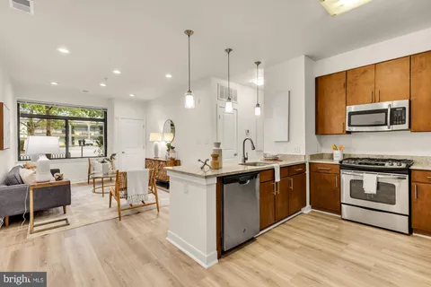 a kitchen with stainless steel appliances kitchen island granite countertop a sink and cabinets